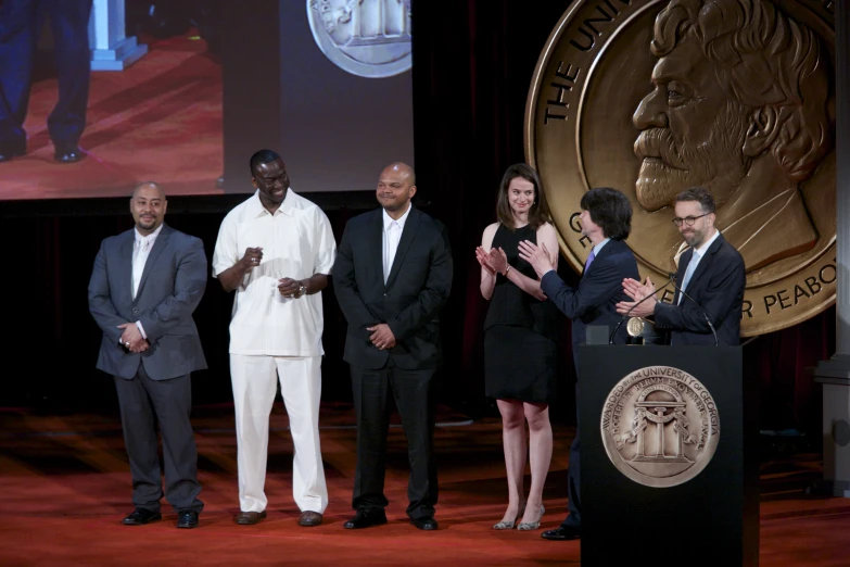 there are many people standing on a stage