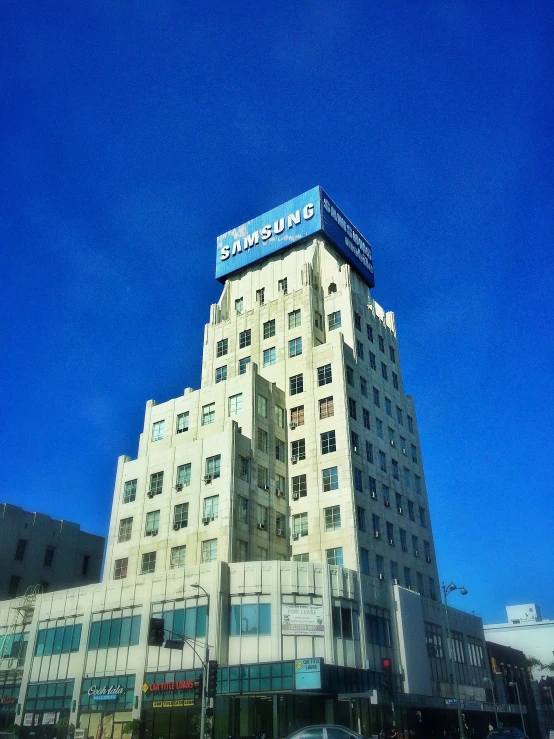 a large white building with a blue sign on top of it