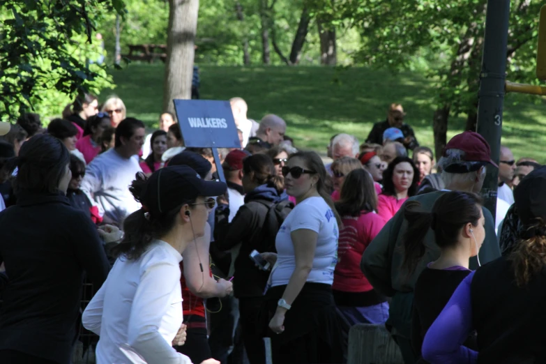 a crowd of people is gathered on the side of a road