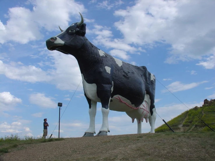 a statue of a cow that is in the dirt