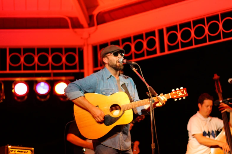 a man holding a guitar at a concert