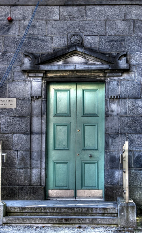 a large green door to an empty building