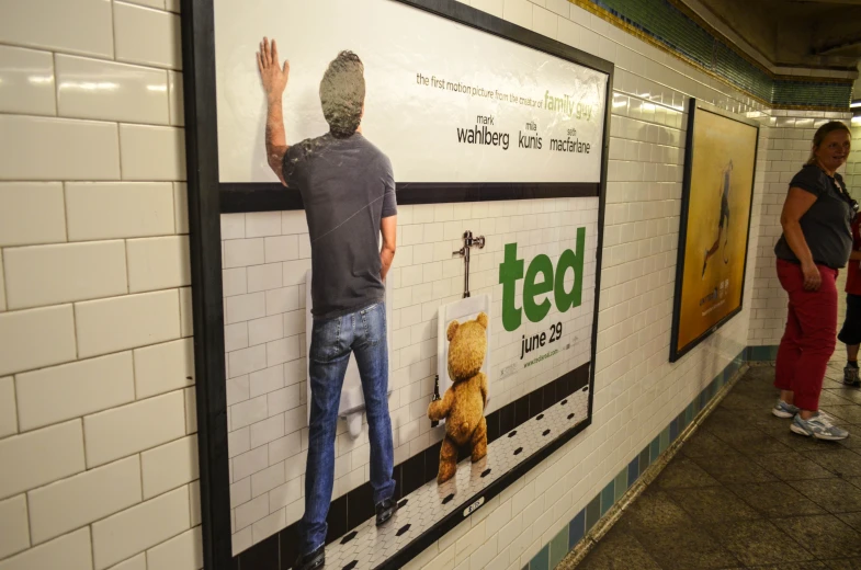 a man that is standing up next to a movie poster