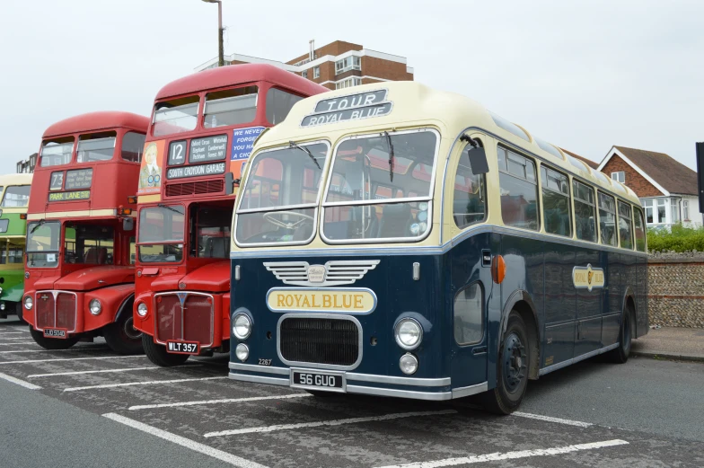 several buses are parked in a lot outside