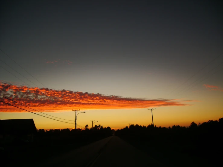 the sky at dusk with telephone wires in it