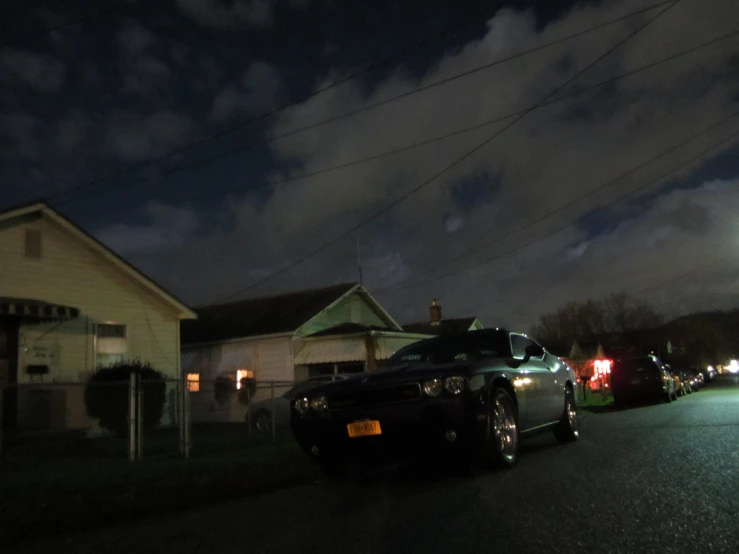 a car on the street at night with its headlights turned