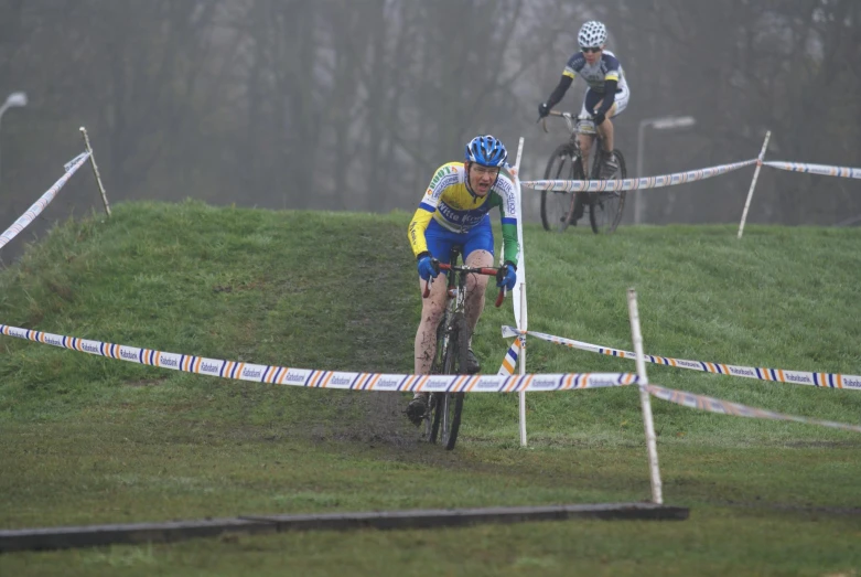 two people on bicycles racing around a course