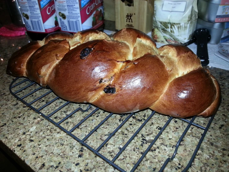 some rolls of bread laying on top of a metal rack