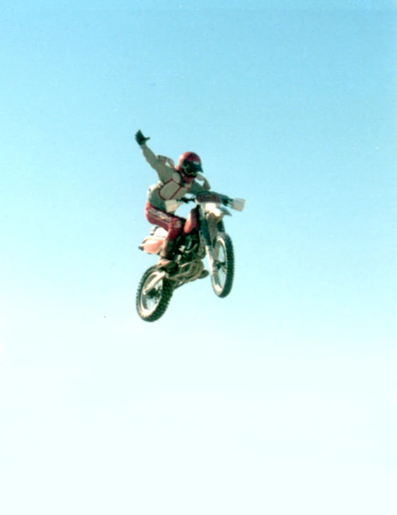 a person jumping high in the air with a motorcycle