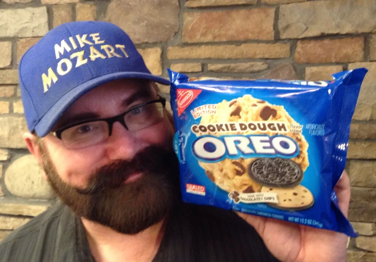 a person holding a bag of cookie dough and a hat