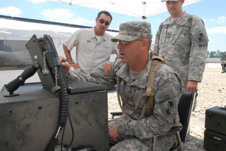 a man in camouflage is next to a fighter jet