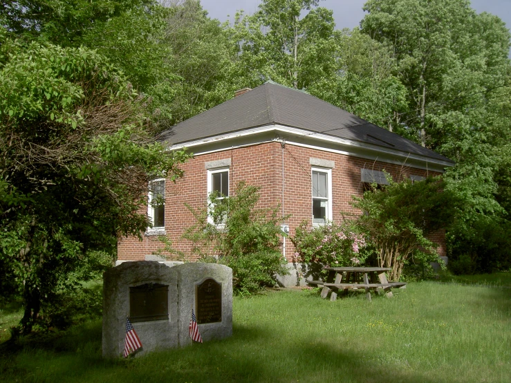 a large red brick building in the middle of some trees