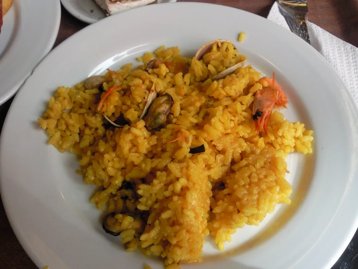 an asian dish with rice, clams and a mussel on it