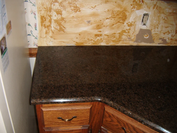 brown, black and white granite countertops in an old kitchen