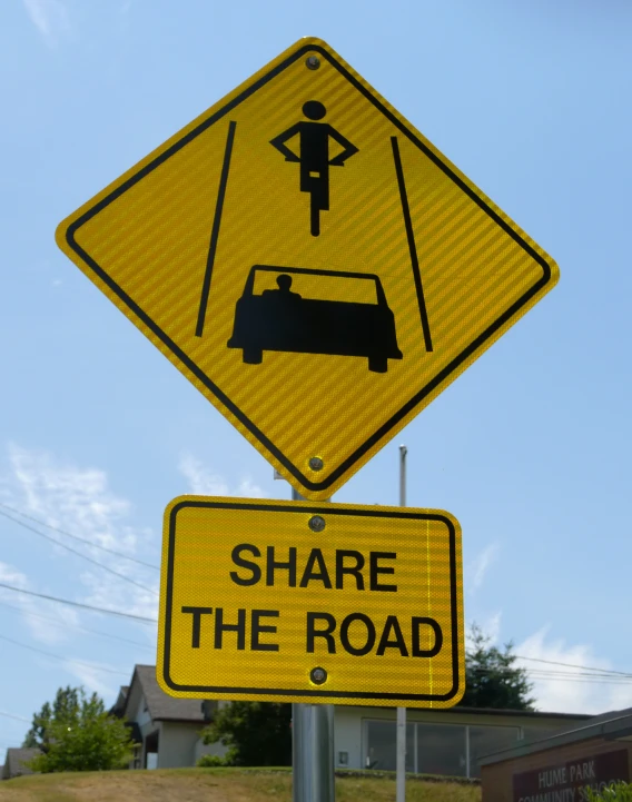 there is a sign that says share the road