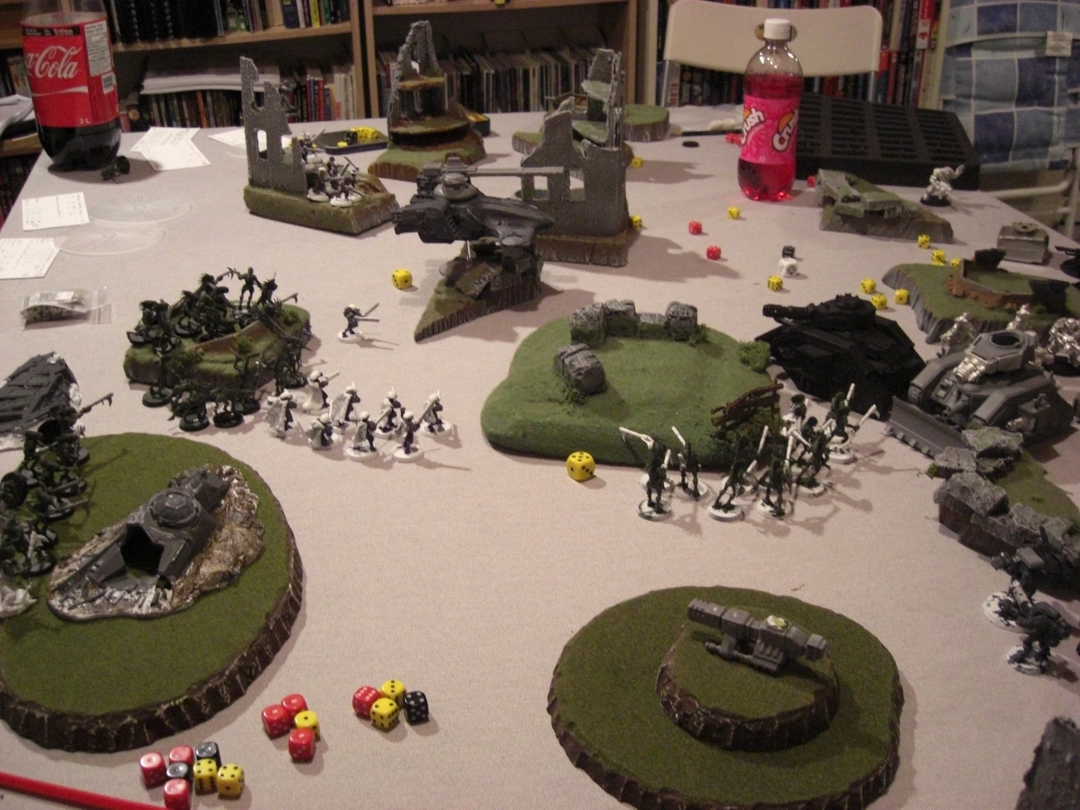 small army bases on display in a room with book shelves