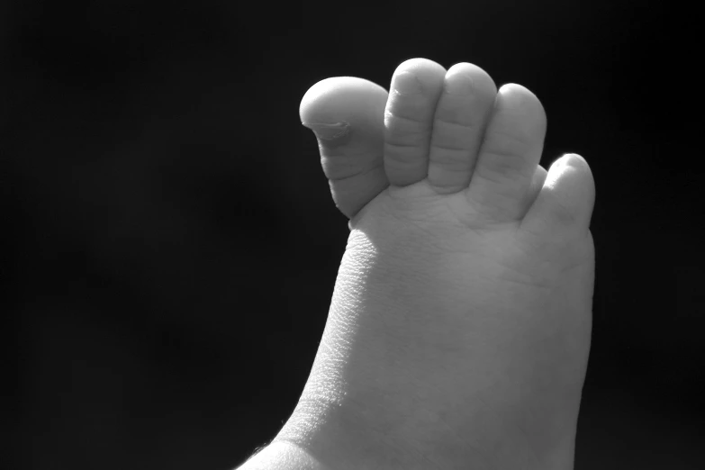 a tiny baby's foot sticking out of the palm