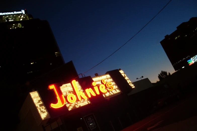 the john's marquee is lit up at night