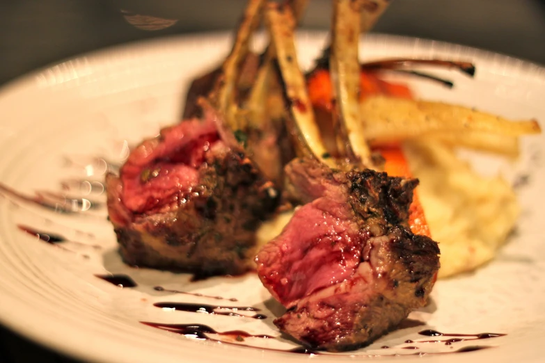 a plate containing steak, vegetables and sauce