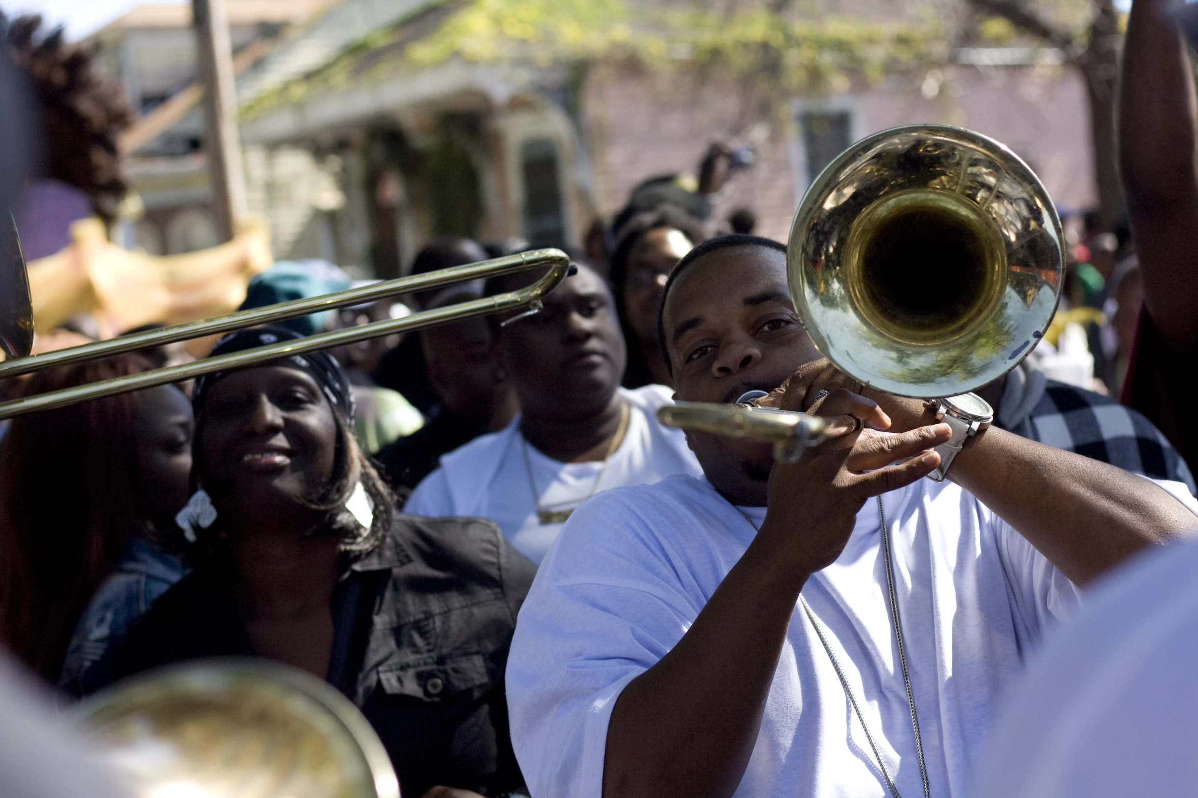 a man that is playing a trombone in a group