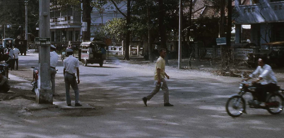 a group of men are talking on the side of the road