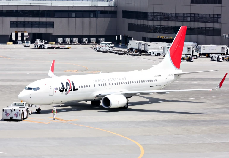 an airliner is preparing to leave the hangar