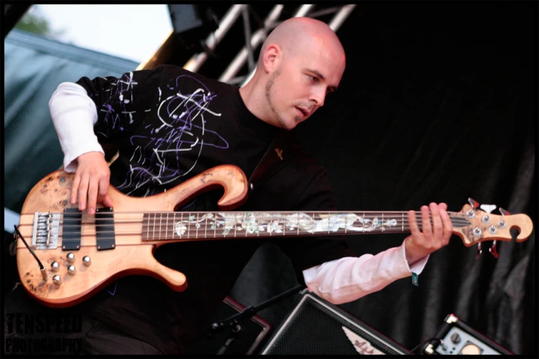 a man playing an electric guitar on stage