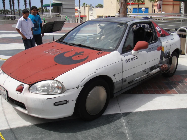 a white and red car with a darth vader design