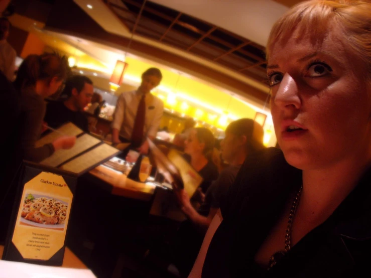 an image of a lady in a restaurant looking on