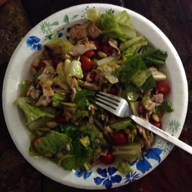 there is a salad in a bowl with a fork