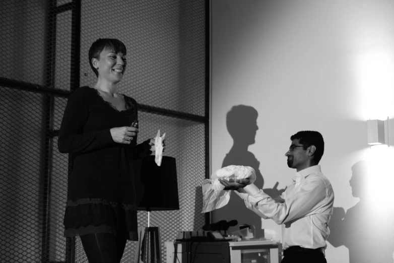 a man holds a woman's hand in a living room