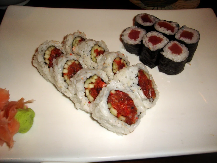 several sushi pieces laid on a white plate