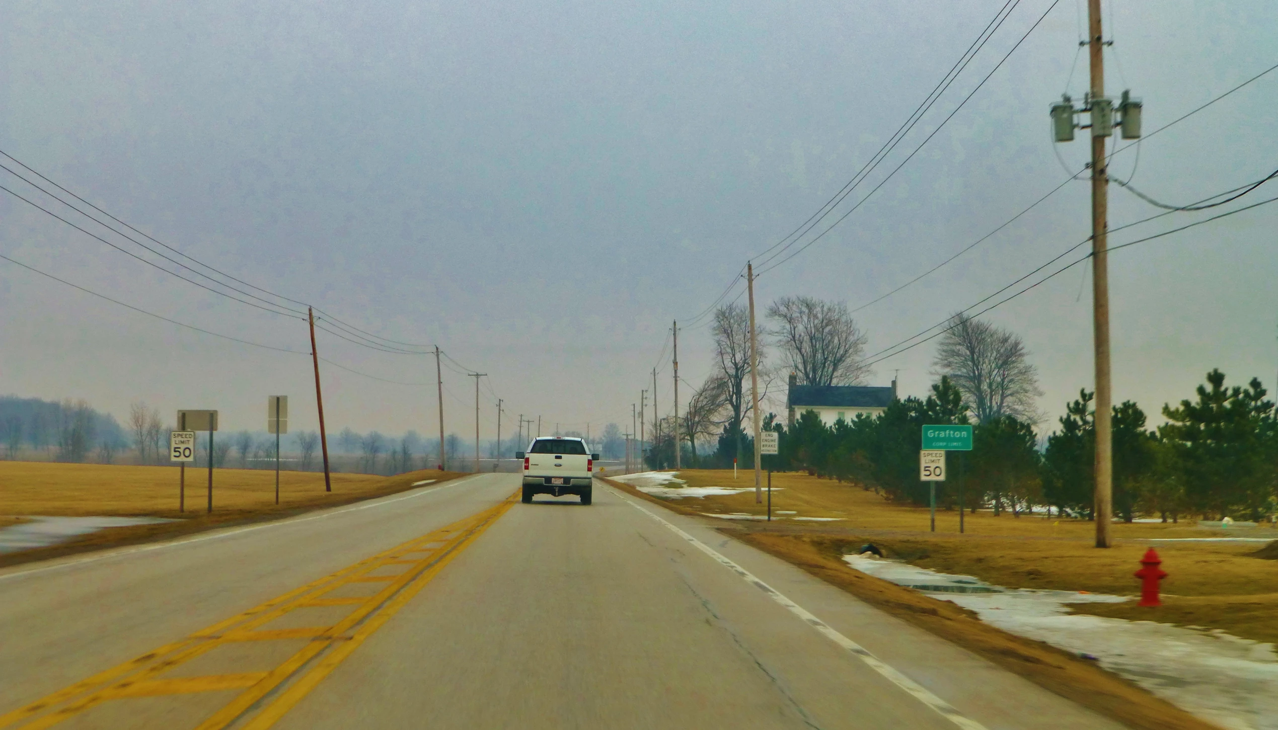 a truck is driving down the street near signs