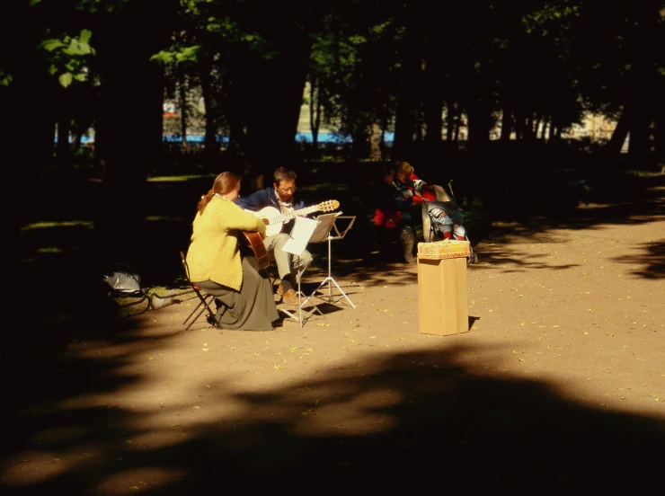 two people setting up food and talking in the shade