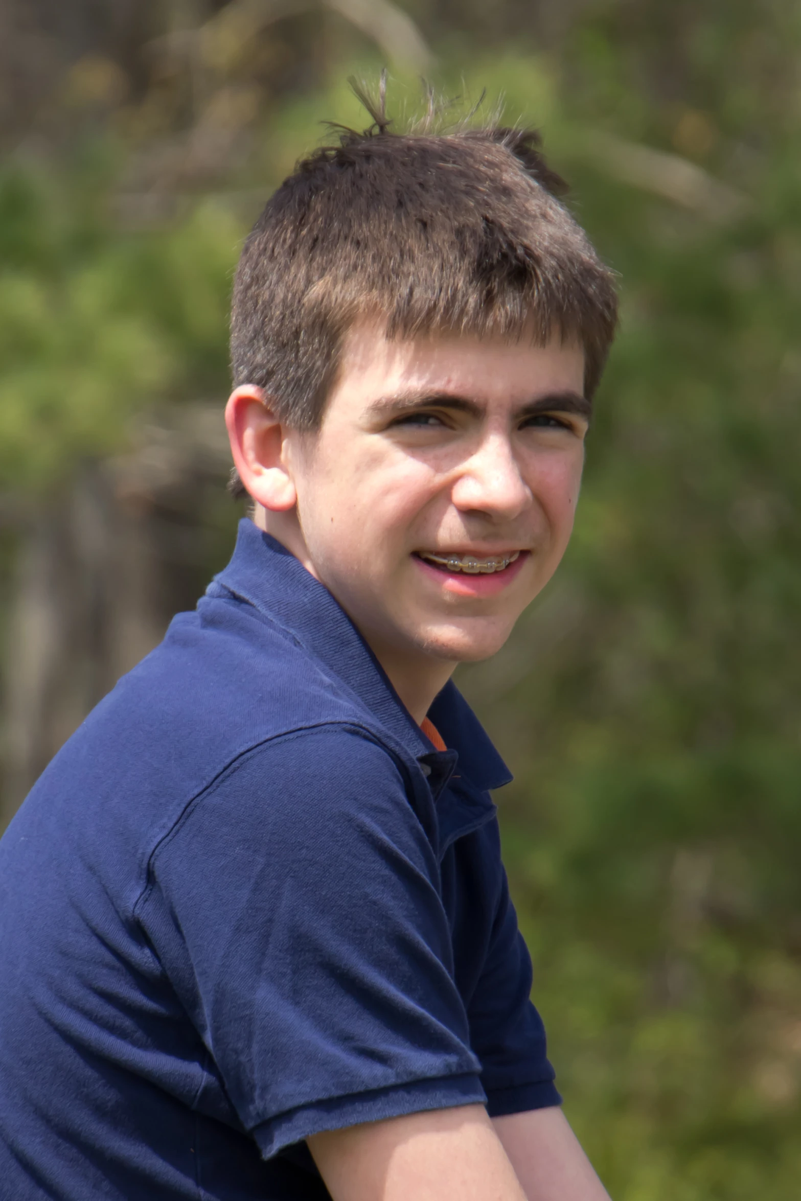 a man is wearing a blue shirt posing for a po