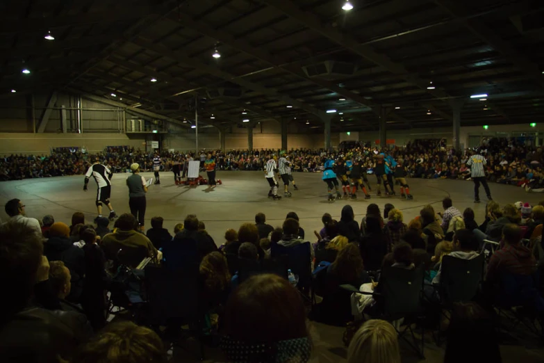 a group of people playing a game with skate boards