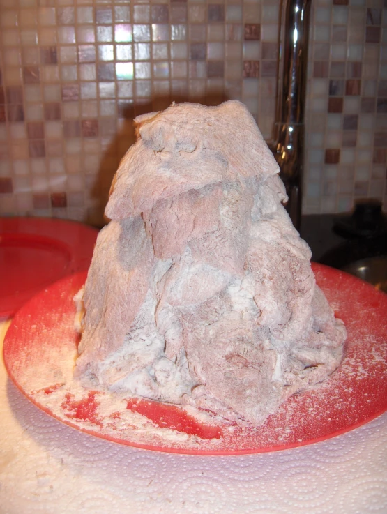 a large rock is in a bowl with flour on the top