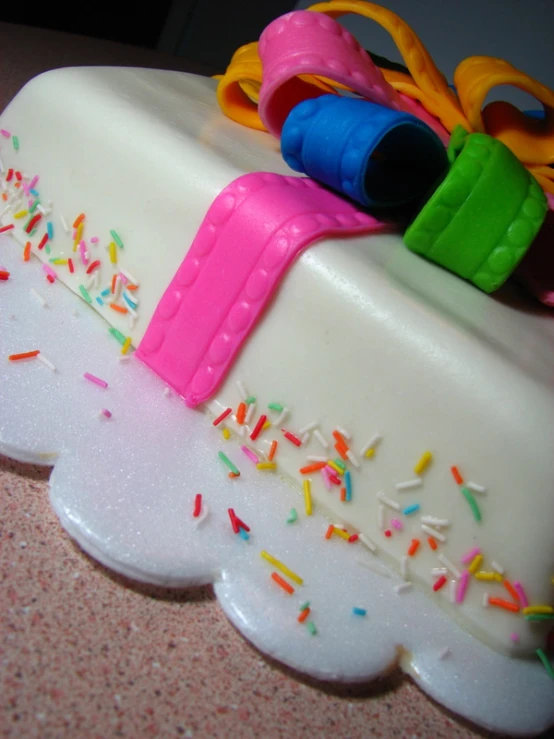 a cake covered in icing with a box attached to it