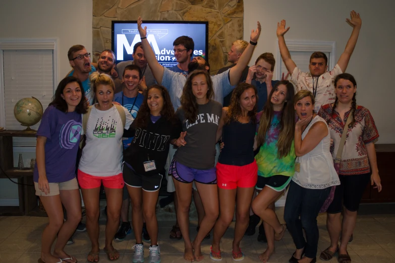 group of people posing for po while posing with tv