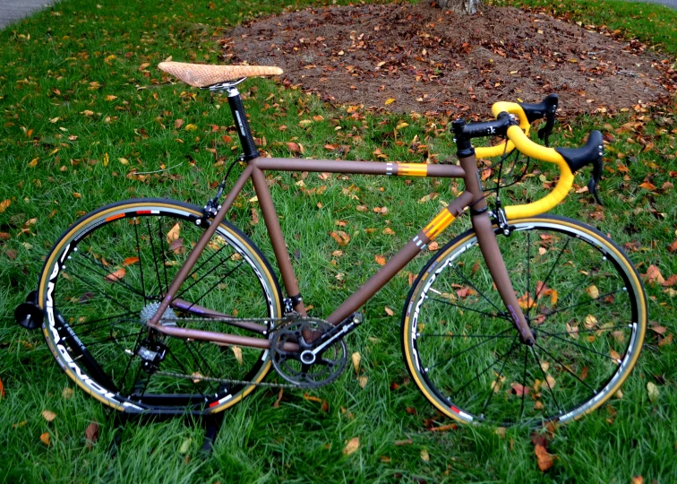 a bike is  to the ground with a yellow handlebar