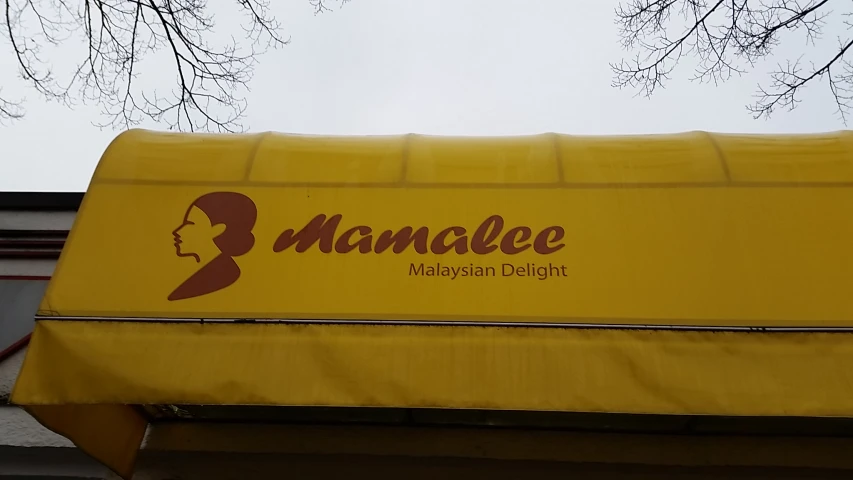 an awning covering the top of a yellow umbrella