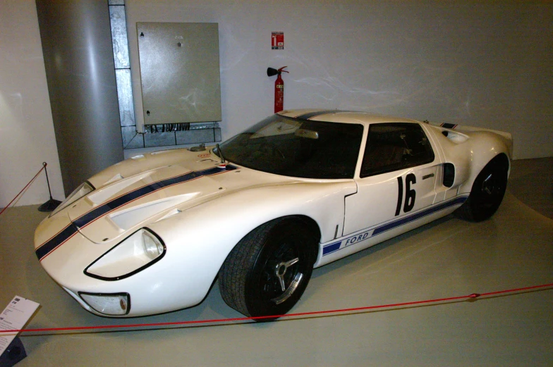 a white car on display at the museum