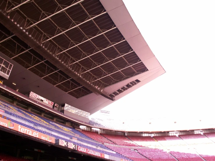 some seats in a stadium with lights overhead