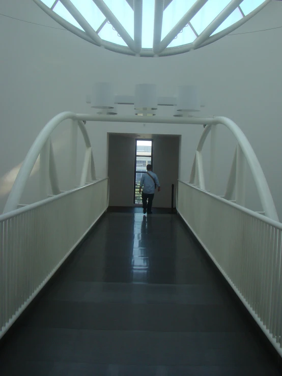 a person with a suitcase is walking along a hallway