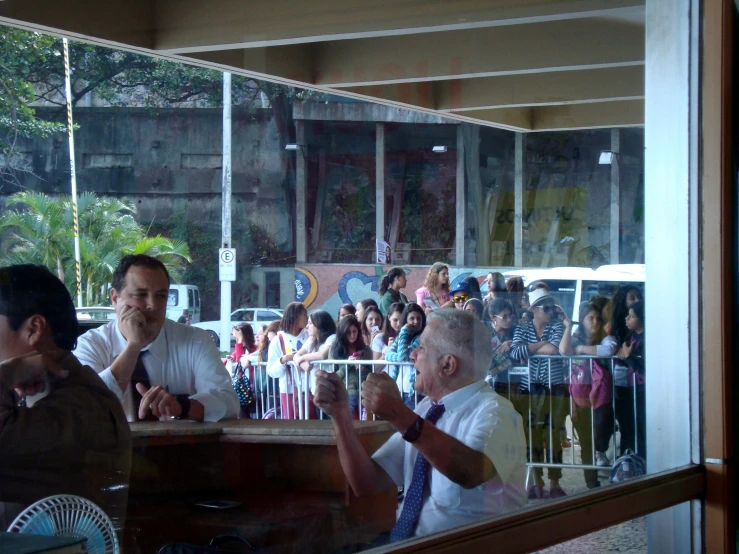 two men are sitting at a counter, smiling