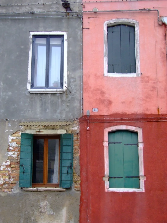 three buildings with different windows and two closed