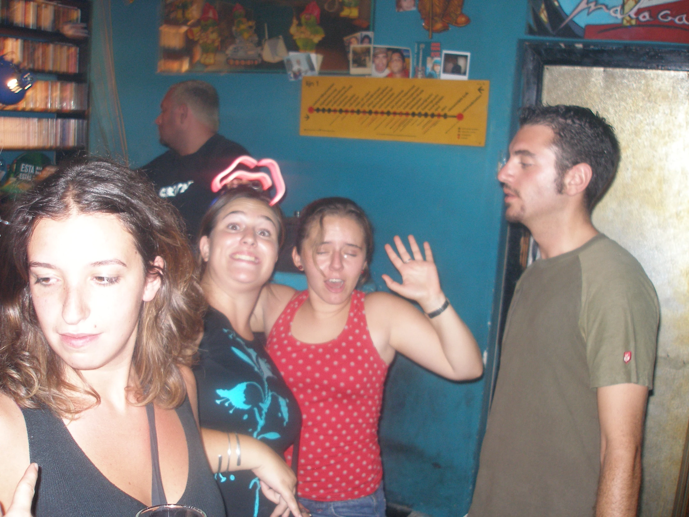 a group of friends standing in a bar holding beers