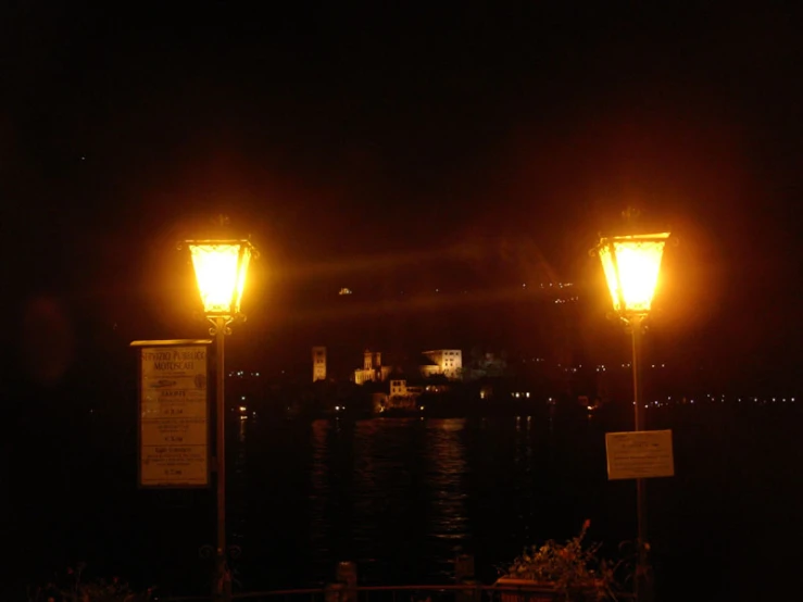 a couple of street lights on top of a wooden post