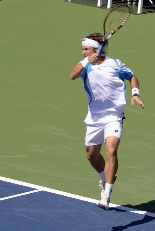 the man in a blue shirt is playing tennis