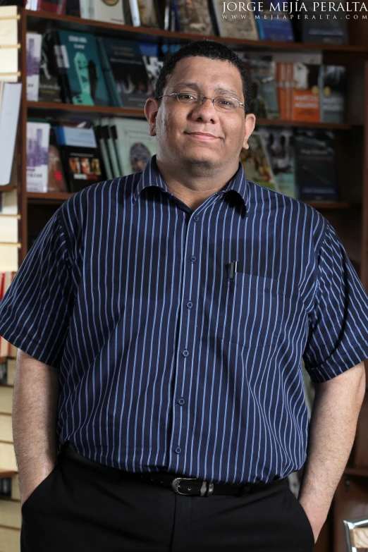 a man in striped shirt and pants posing for po